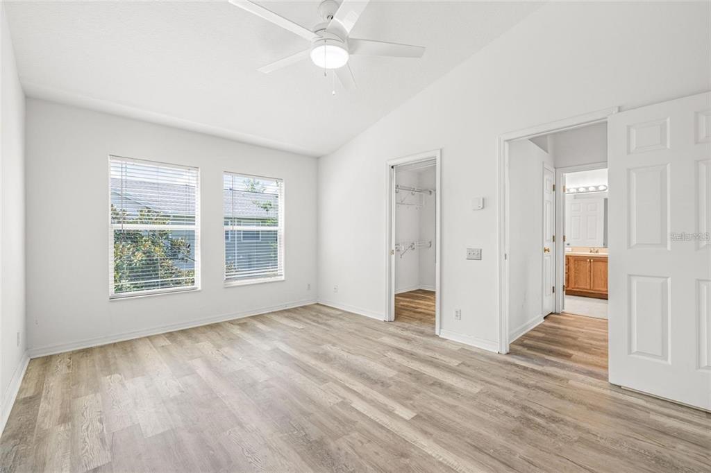 8010 Thoroughbred Loop Largo, FL 33773 - Photo 17 of 29 a view of an empty room with wooden floor and a window