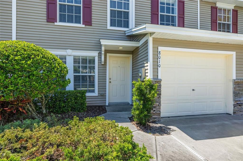 8010 Thoroughbred Loop Largo, FL 33773 - Photo 2 of 29 a front view of a house having yard