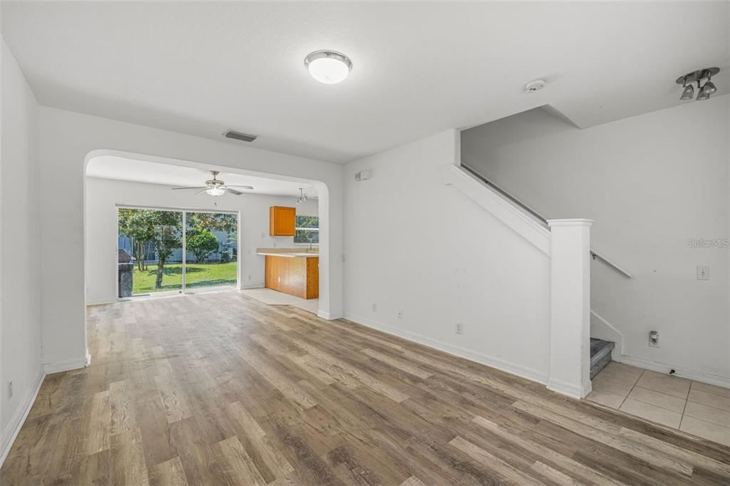 8010 Thoroughbred Loop Largo, FL 33773 - Photo 5 of 29 a view of an empty room with a window and wooden floor
