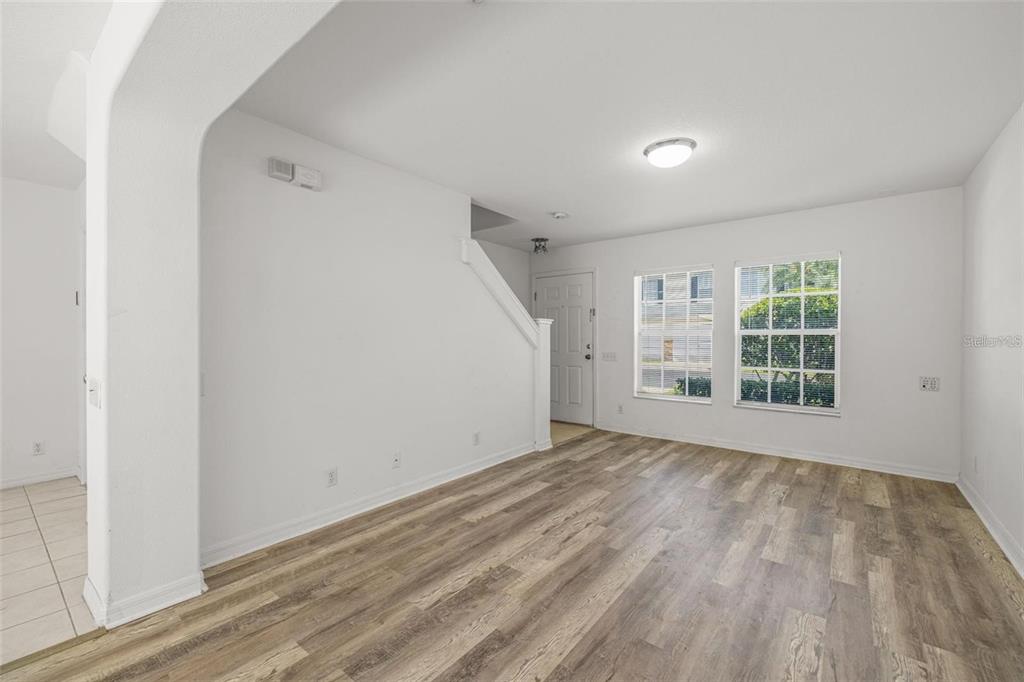 8010 Thoroughbred Loop Largo, FL 33773 - Photo 6 of 29 a view of empty room with wooden floor and fan