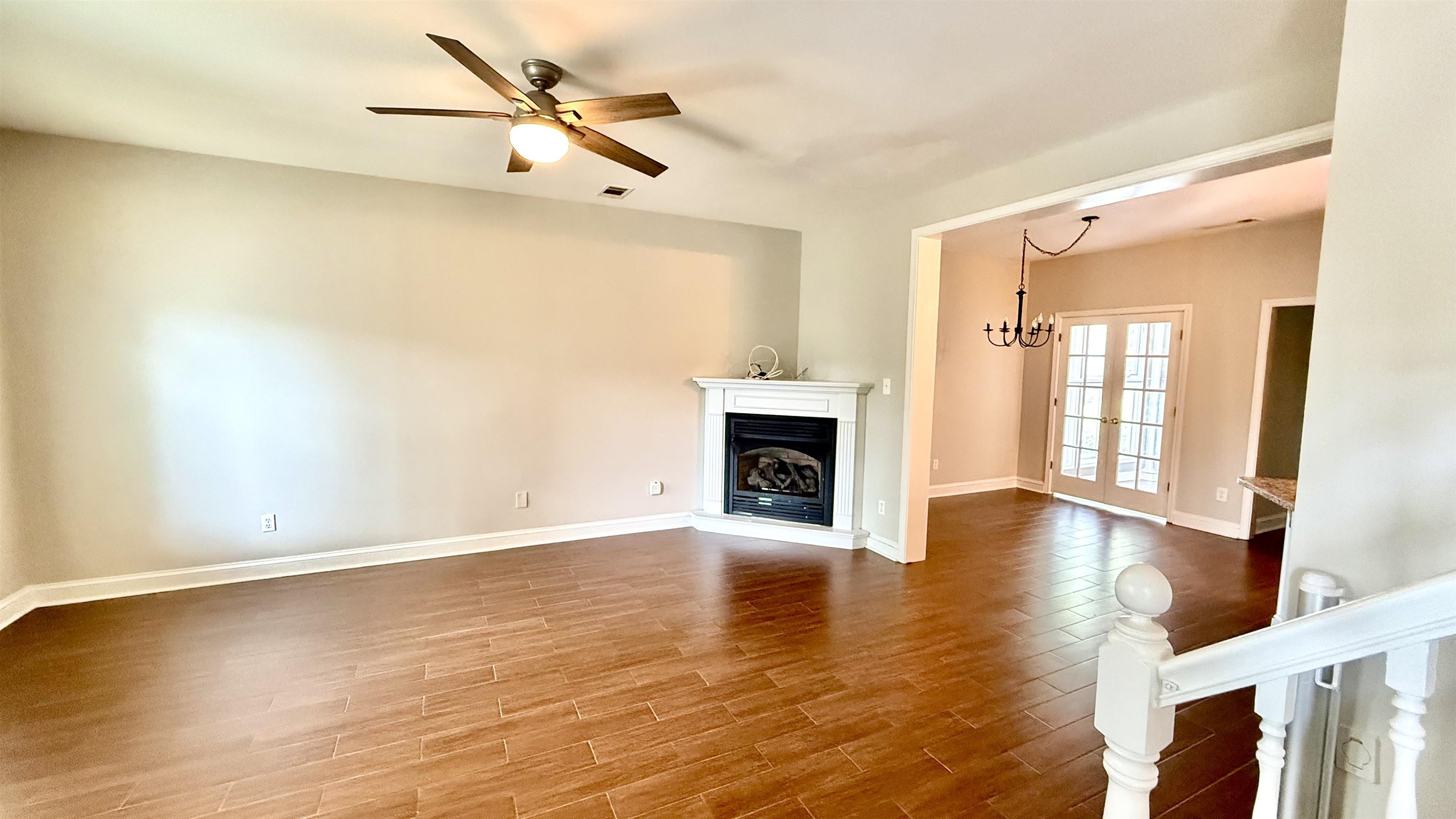 184 Marrakesh Circle Memphis, TN 38103 - Photo 3 of 34 an empty room with wooden floor fireplace and windows
