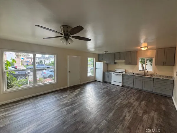 a view of a kitchen with a sink and a window