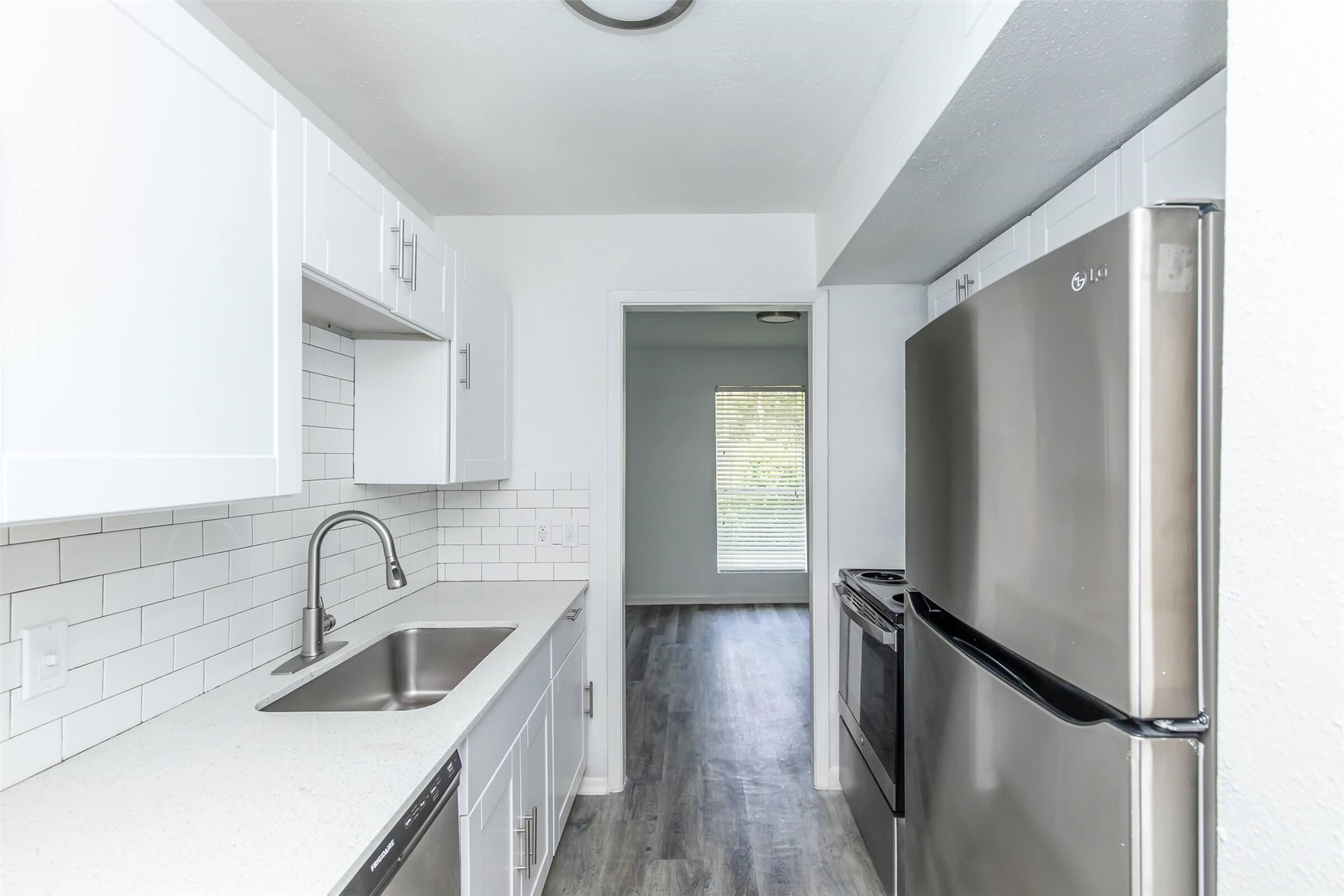 18001 Cypress Trace Road, Unit 2802 Houston, TX 77090 - Photo 6 of 31 a kitchen with sink a refrigerator and window