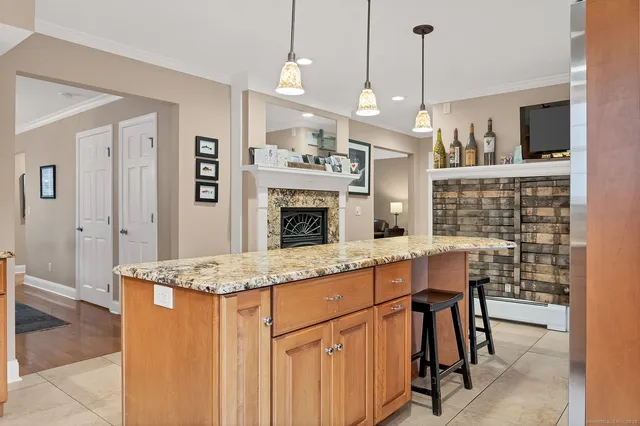 a open kitchen with stainless steel appliances granite countertop wooden floors and white cabinets