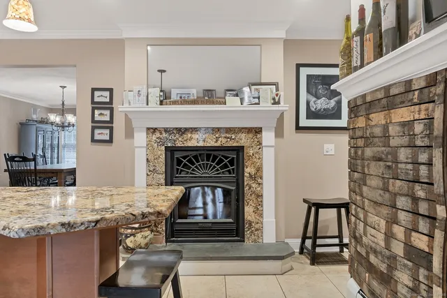 a living room with granite countertop furniture and a fireplace
