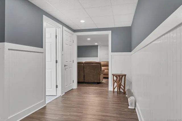 a view of a hallway with wooden floor