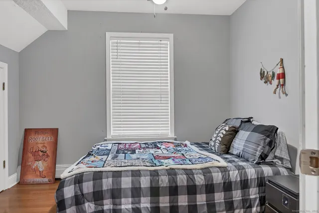 a bedroom with a bed and a window