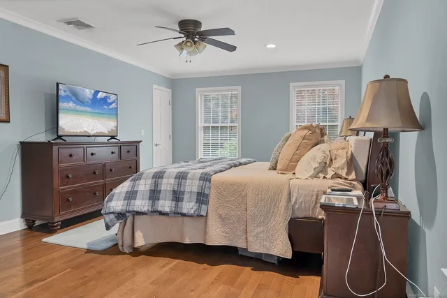 a bed room with a bed and a flat tv screen