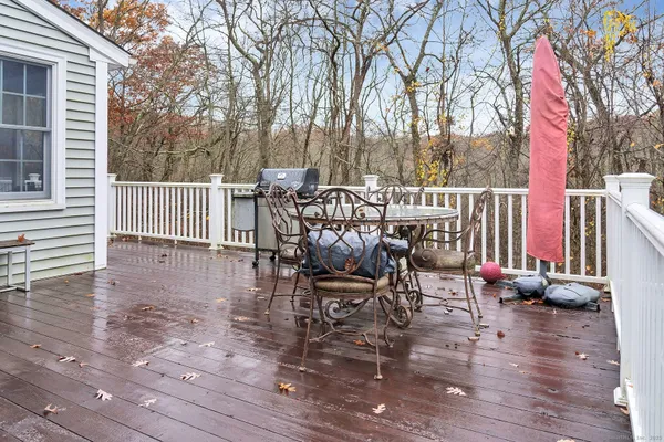 a view of a patio with a table chairs and wooden floor