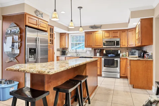 a kitchen with stainless steel appliances granite countertop a sink and counter space