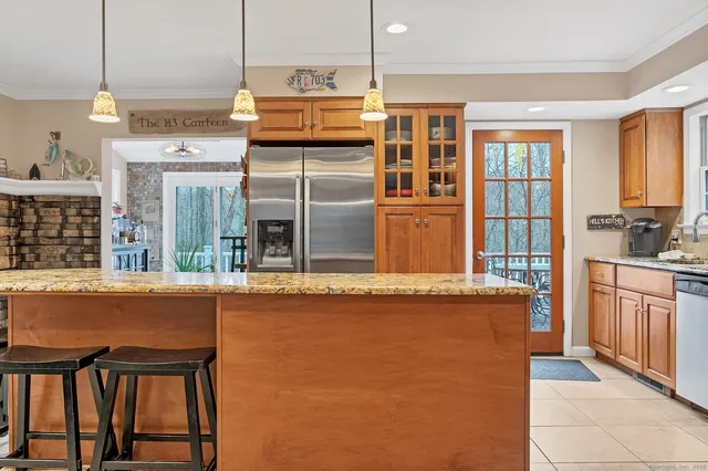 a kitchen with stainless steel appliances granite countertop a stove and a refrigerator