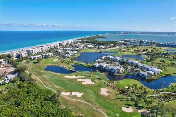 an aerial view of a houses with a lake view