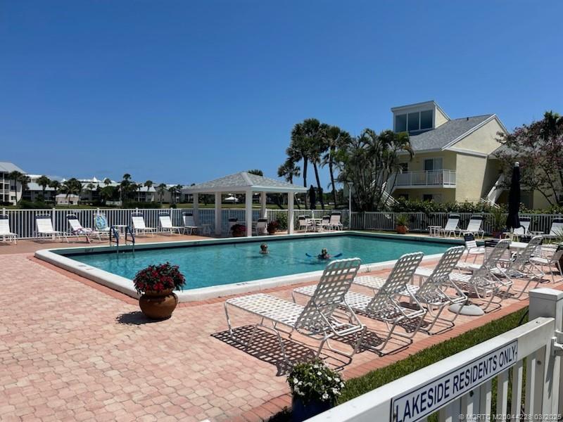 5565 Northeast Gulfstream Way Stuart, FL 34996 - Photo 18 of 21 a view of a swimming pool with a patio