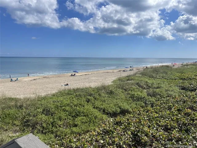 a view of a pathway both side of grassy field with shrub
