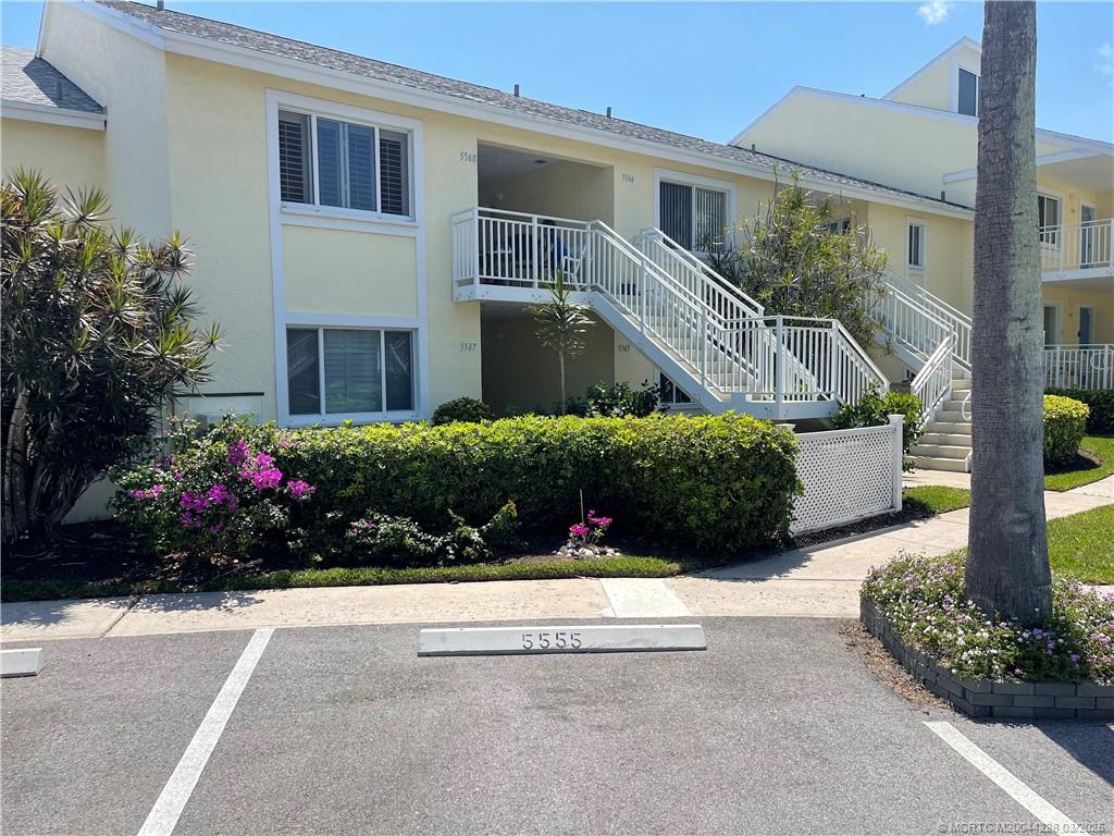 5565 Northeast Gulfstream Way Stuart, FL 34996 - Photo 5 of 21 a view of a house with a garden