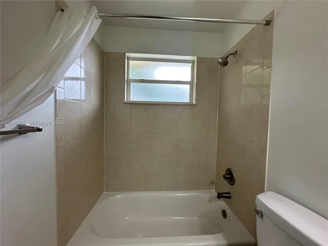 a bathroom with a bathtub and a toilet