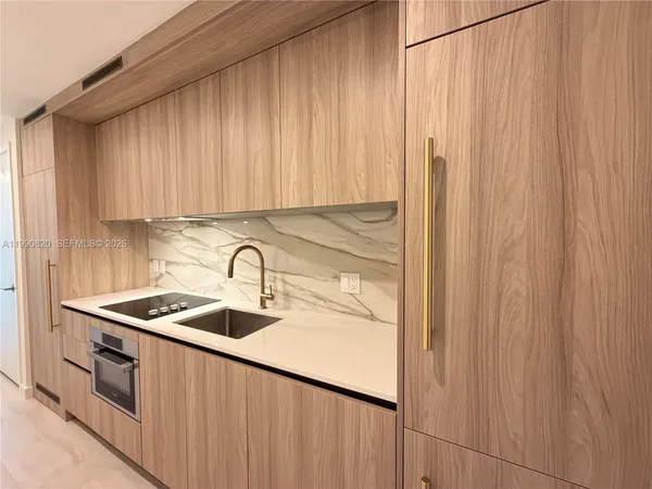 a kitchen with stainless steel appliances a sink and a cabinets