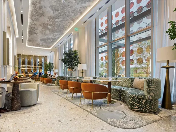 a living room with furniture and a floor to ceiling window