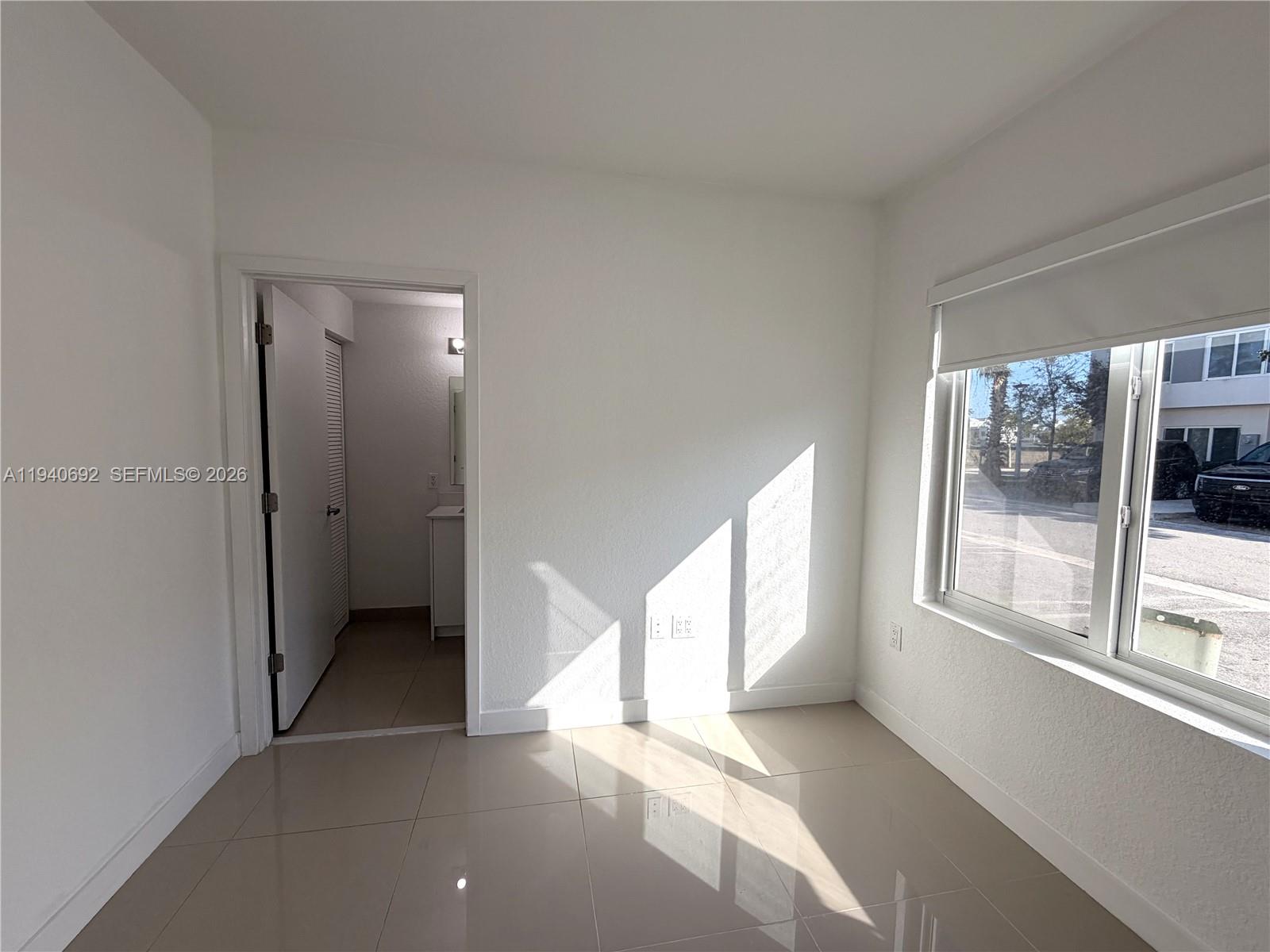 25823 Southwest 145th Avenue Miami, FL 33170 - Photo 11 of 18 a view of an empty room and window