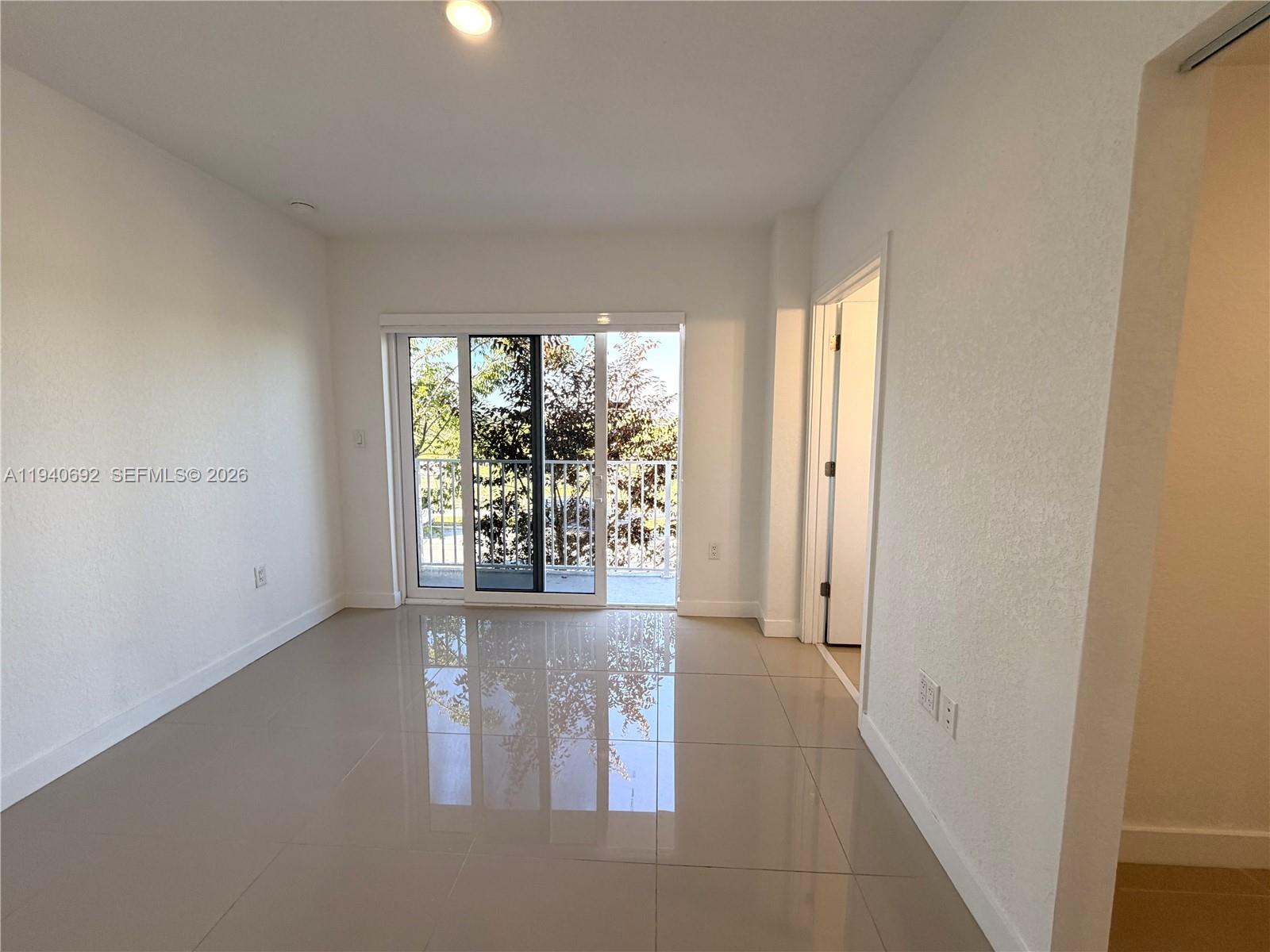 25823 Southwest 145th Avenue Miami, FL 33170 - Photo 12 of 18 an empty room with windows and entrance