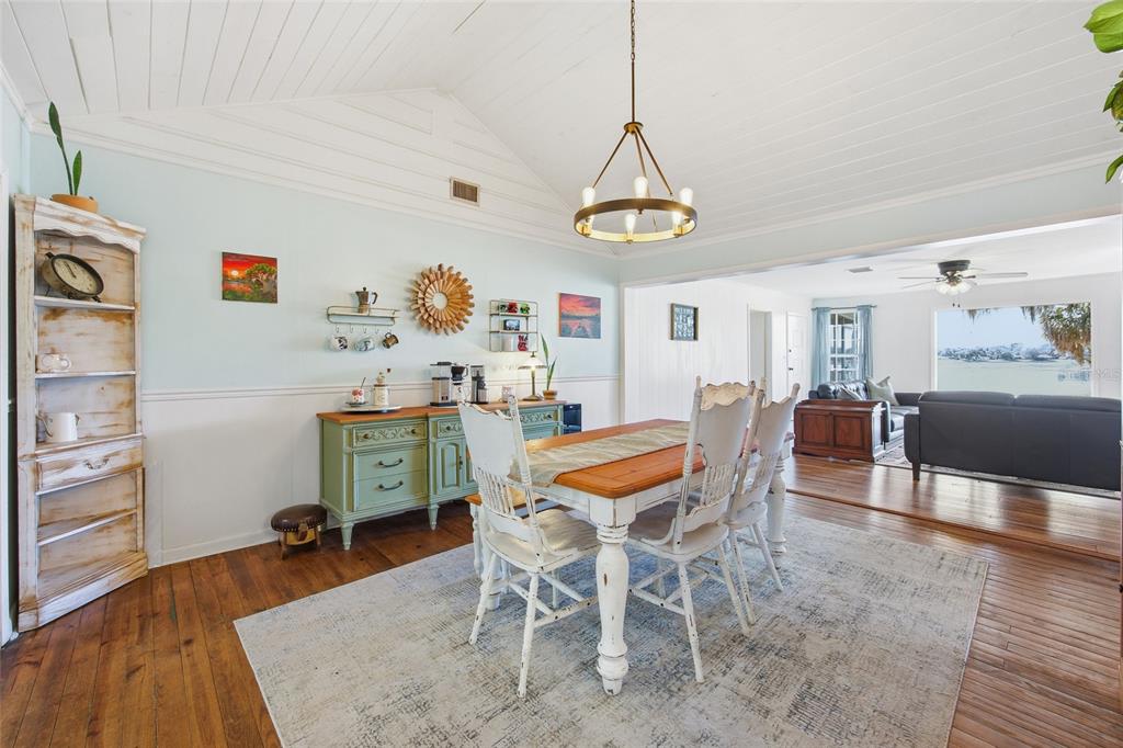 10550 Northeast 222nd Place Road Fort McCoy, FL 32134 - Photo 13 of 48 a dining room with furniture a chandelier and wooden floor