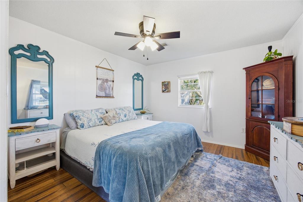 10550 Northeast 222nd Place Road Fort McCoy, FL 32134 - Photo 19 of 48 a bedroom with a bed and a flat tv screen on dresser