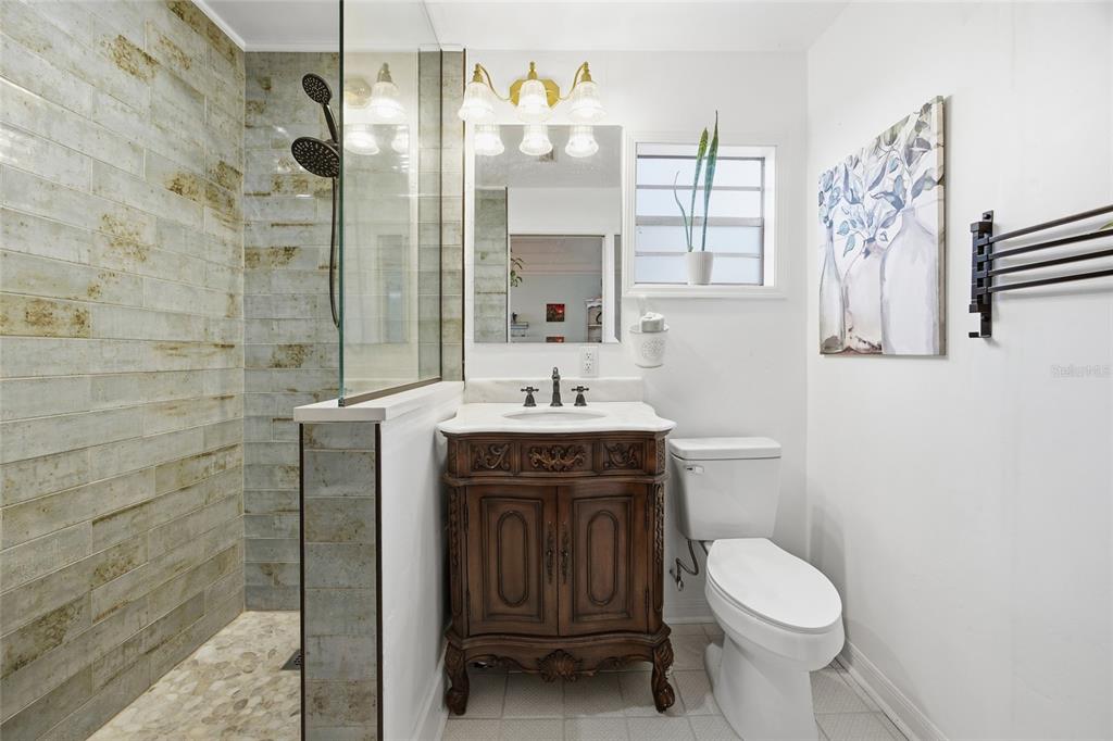 10550 Northeast 222nd Place Road Fort McCoy, FL 32134 - Photo 21 of 48 a bathroom with a sink a toilet and shower