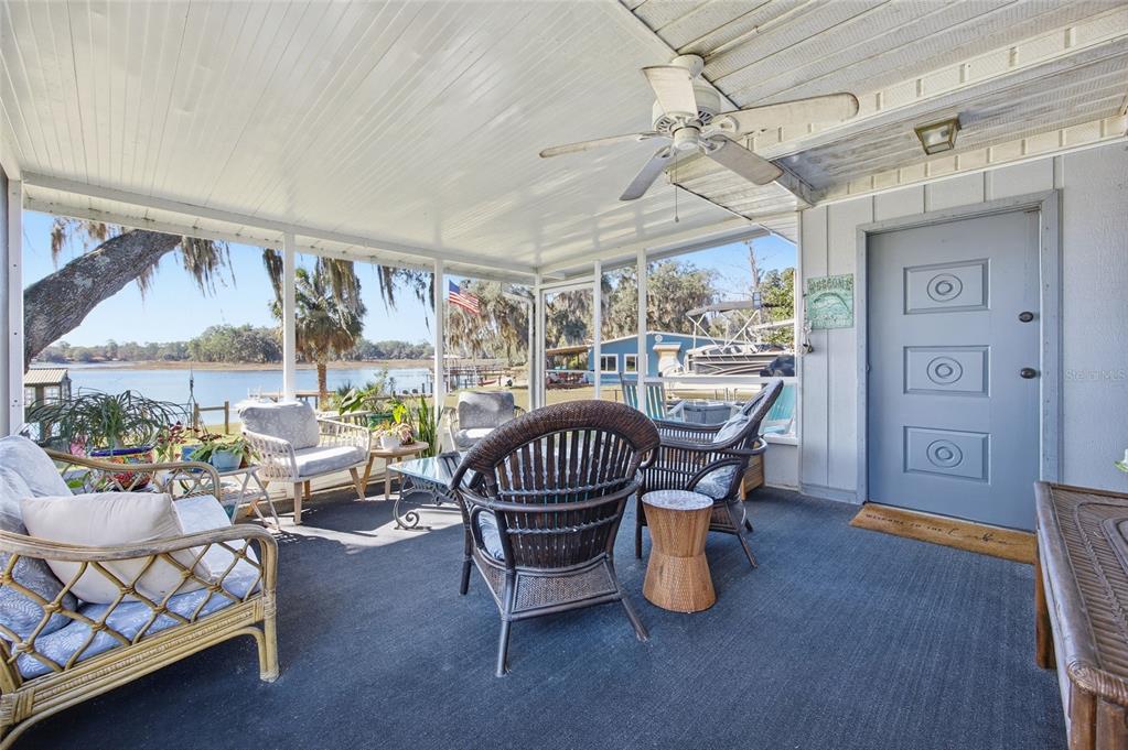 10550 Northeast 222nd Place Road Fort McCoy, FL 32134 - Photo 3 of 48 a dining room with furniture a rug and a chandelier