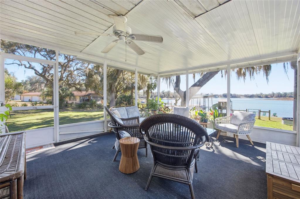 10550 Northeast 222nd Place Road Fort McCoy, FL 32134 - Photo 4 of 48 a view of a dining room with furniture a chandelier and wooden floor