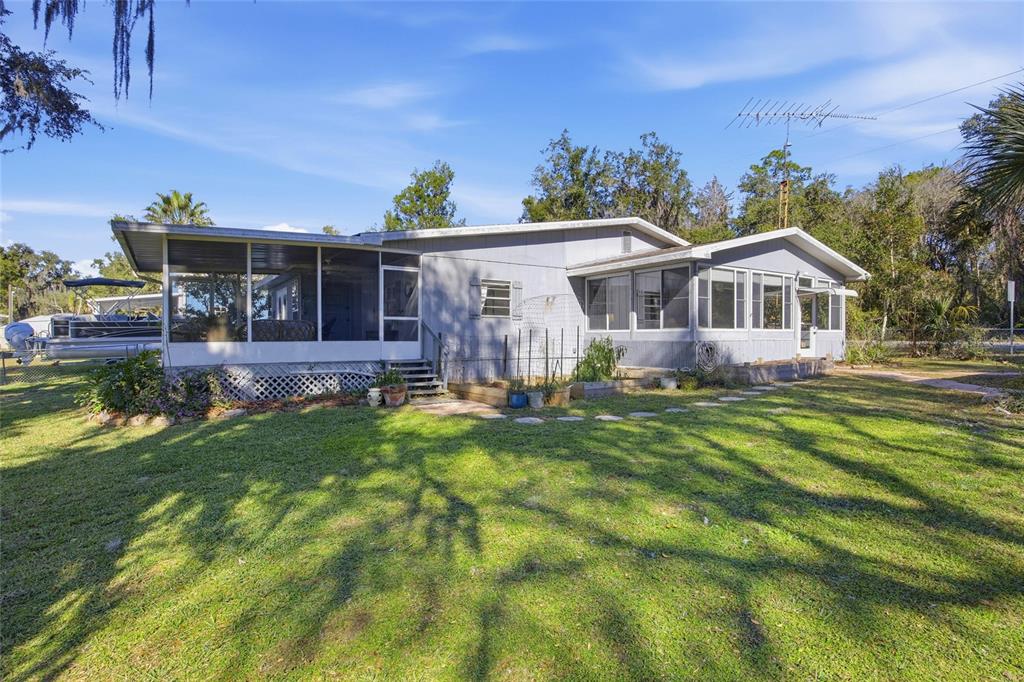 10550 Northeast 222nd Place Road Fort McCoy, FL 32134 - Photo 41 of 48 a front view of a house with a yard table and chairs