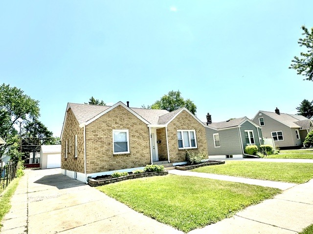 513 Cookane Avenue Elgin, IL 60120 - Photo 3 of 26 a front view of a house with a garden and trees