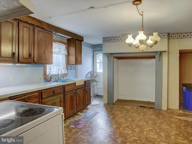 a kitchen with cabinets a sink stainless steel appliances and cabinets