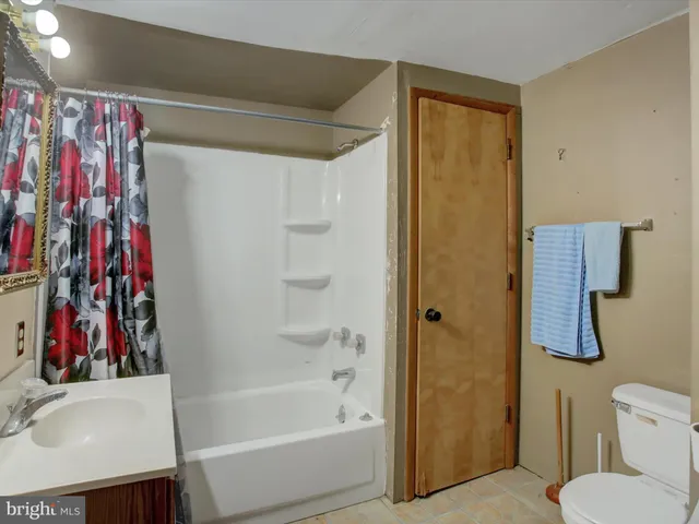 a view of a big house with a big yard and large trees