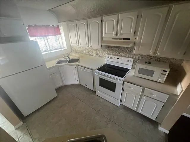 a kitchen with a stove and a refrigerator