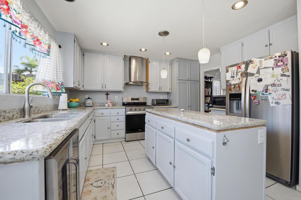 2077 Westwood Road Vista, CA 92083 - Photo 16 of 37 a kitchen with granite countertop a sink a counter top space appliances and cabinets
