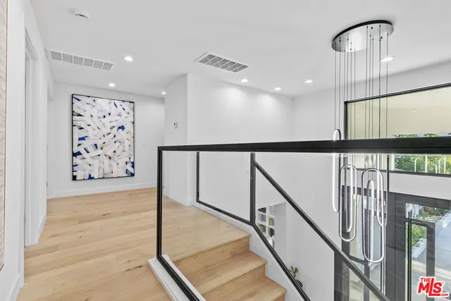a view of a room with a wooden floor and potted plant