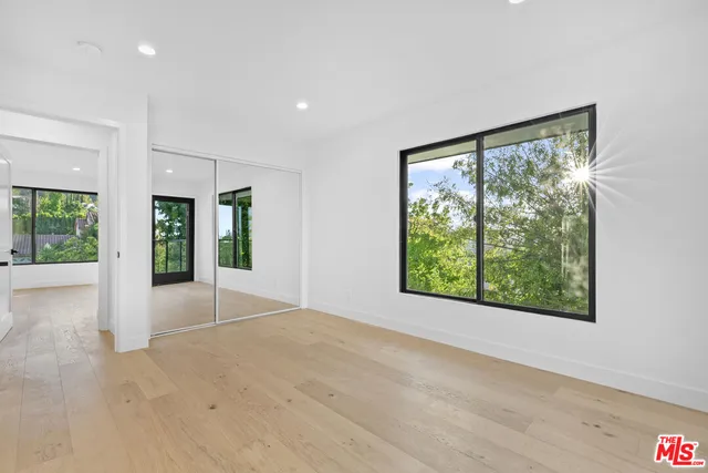 a view of a balcony with couch and wooden floor