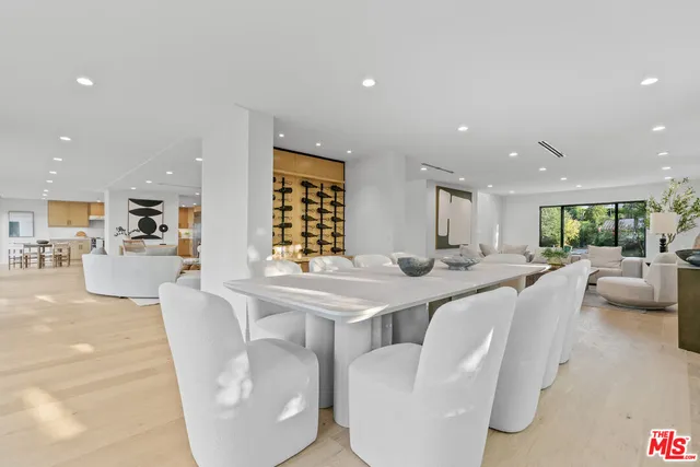 a kitchen with appliances a sink a counter top space and a center island