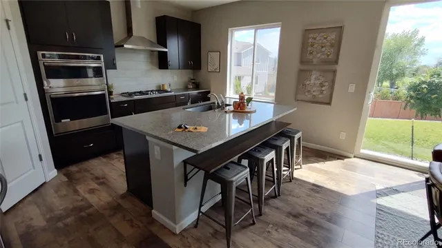 a kitchen with a table chairs and window
