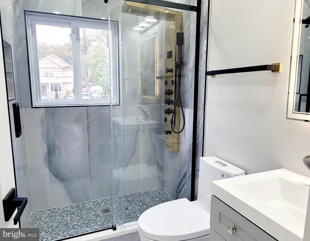 a bathroom with a sink toilet and shower