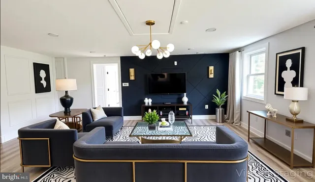 a view of a dining room with furniture and a chandelier