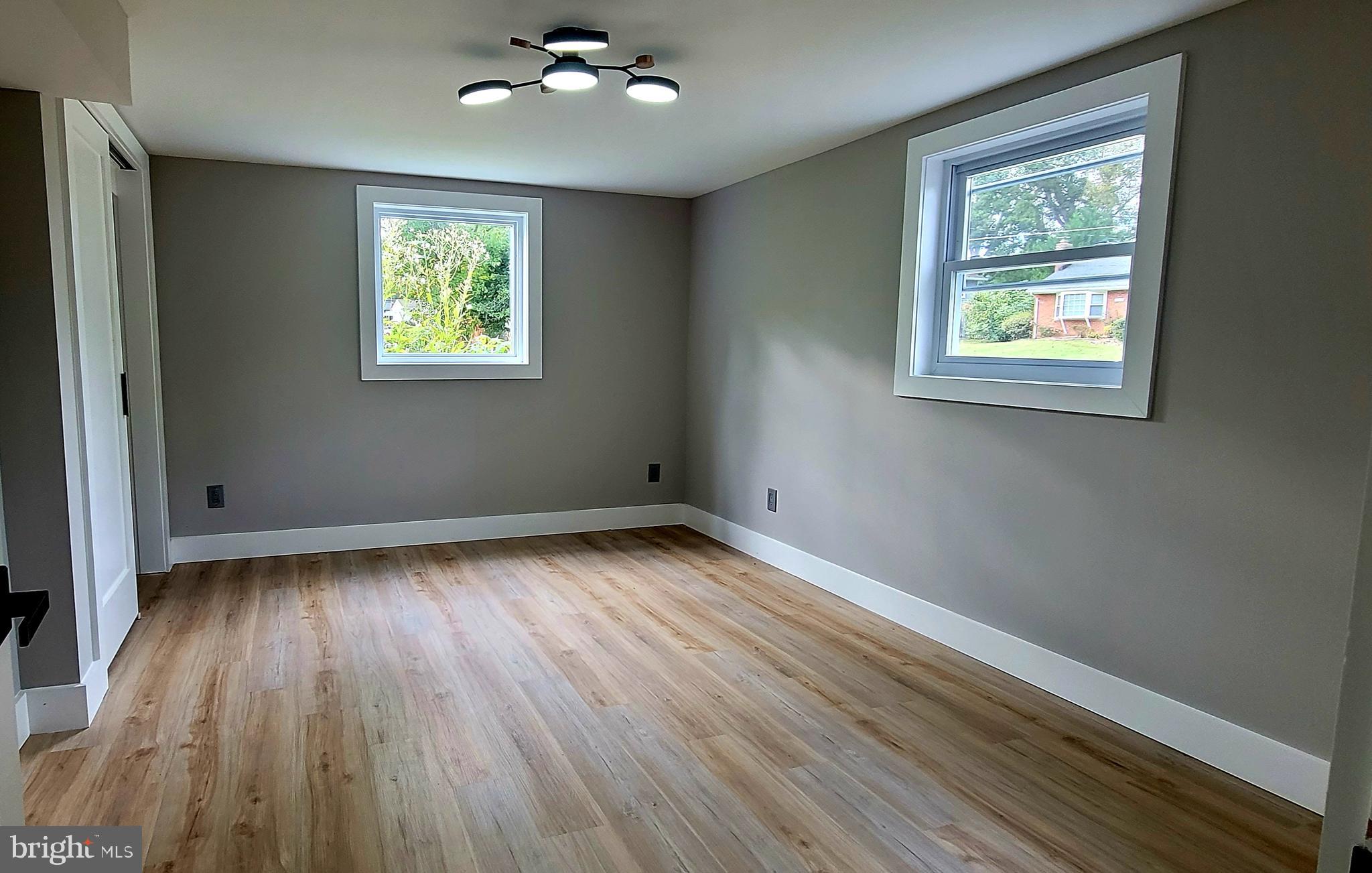 5401 Ferndale Street Springfield, VA 22151 - Photo 28 of 28 a view of an empty room with wooden floor and a window