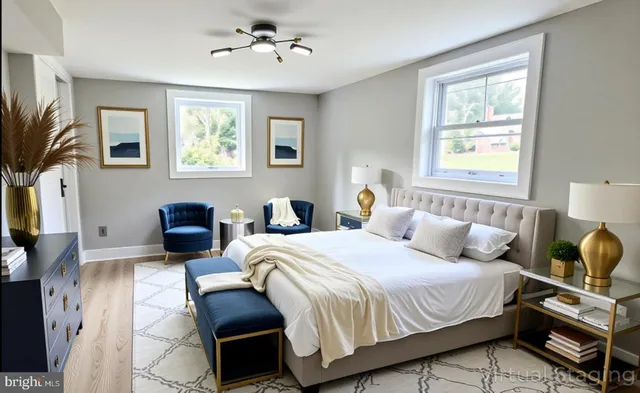 a bedroom with bed a flat tv screen and a dresser