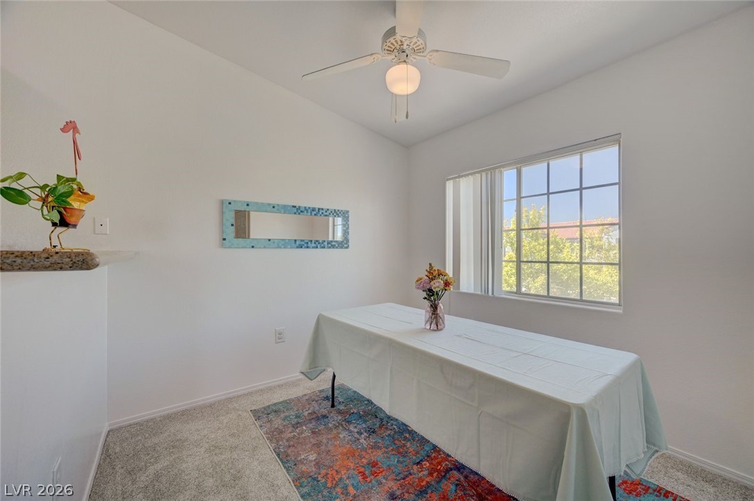 3318 North Decatur Boulevard, Unit 2072 Las Vegas, NV 89130 - Photo 16 of 50 A well-lit dining area featuring a window overlooking greenery, complemented by a ceiling fan for comfort.