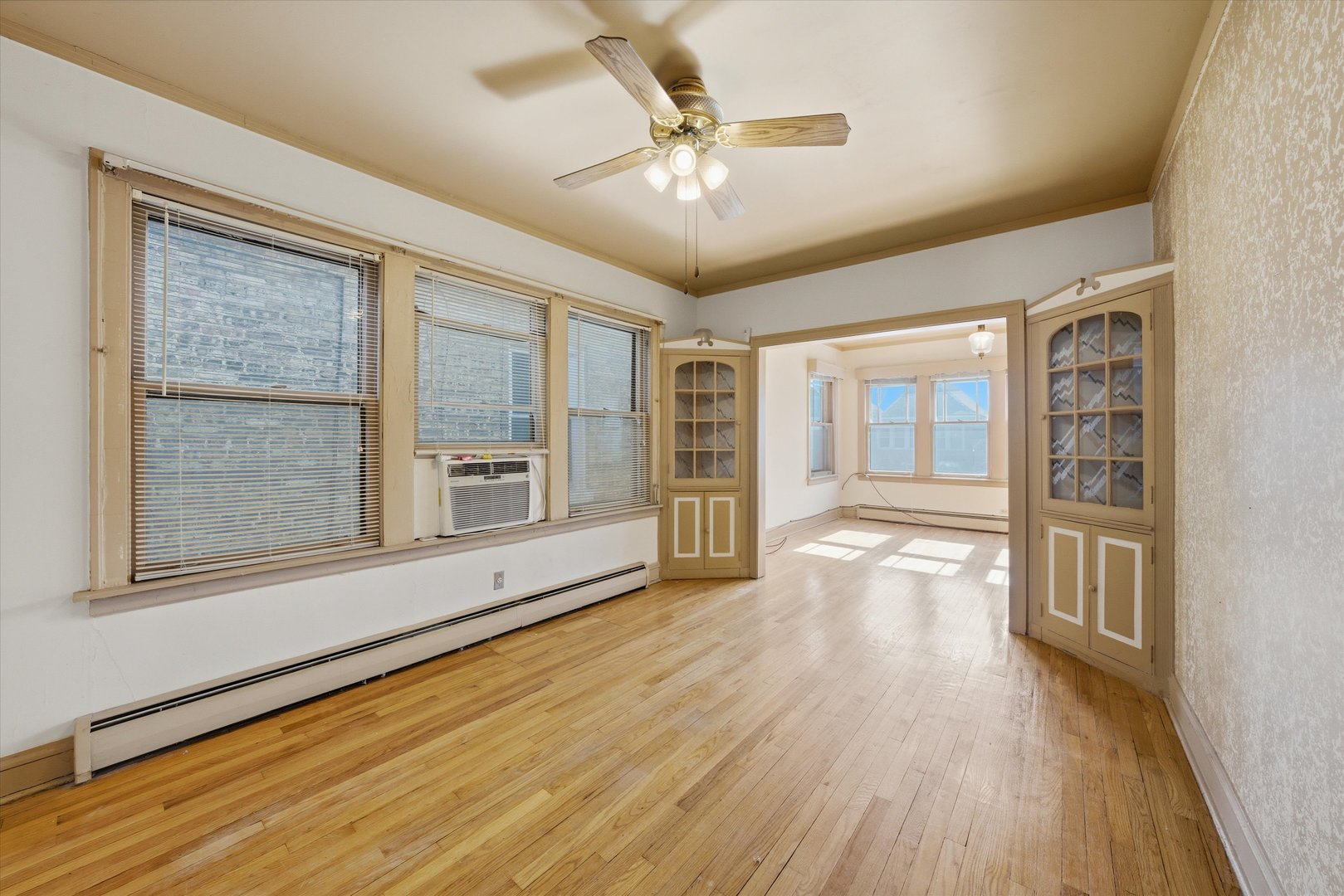 3822 West 64th Street Chicago, IL 60629 - Photo 2 of 33 a view of an empty room with a window and wooden floor