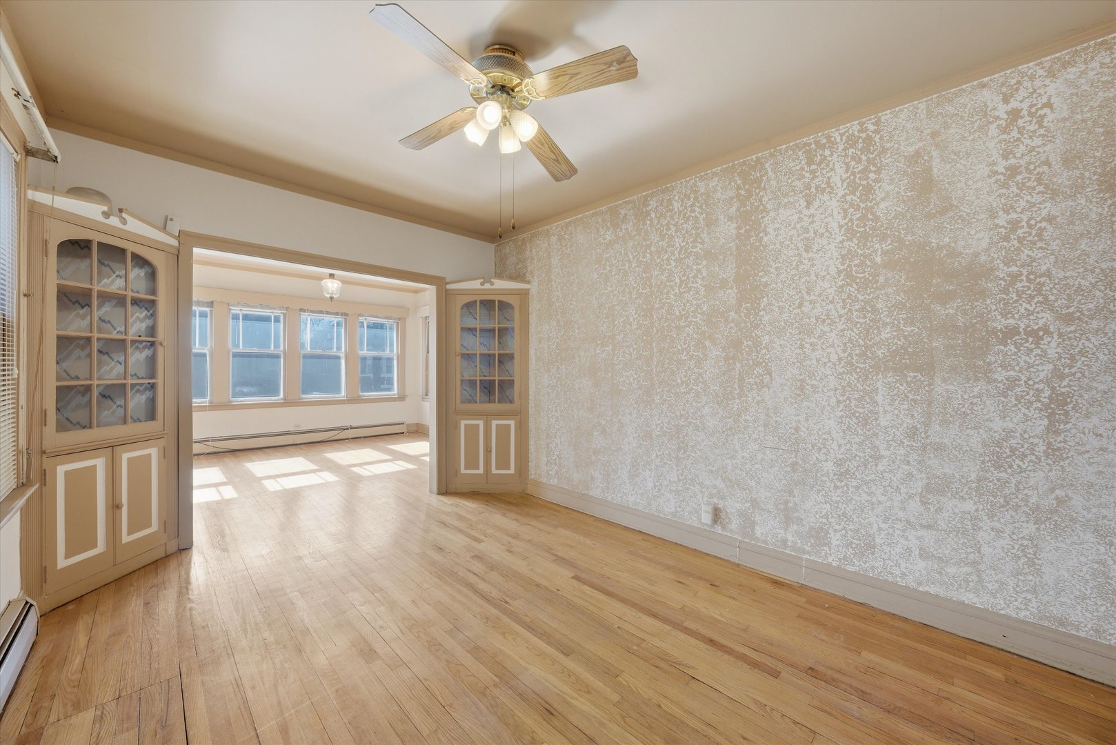 3822 West 64th Street Chicago, IL 60629 - Photo 3 of 33 a view of an empty room with a window and wooden floor