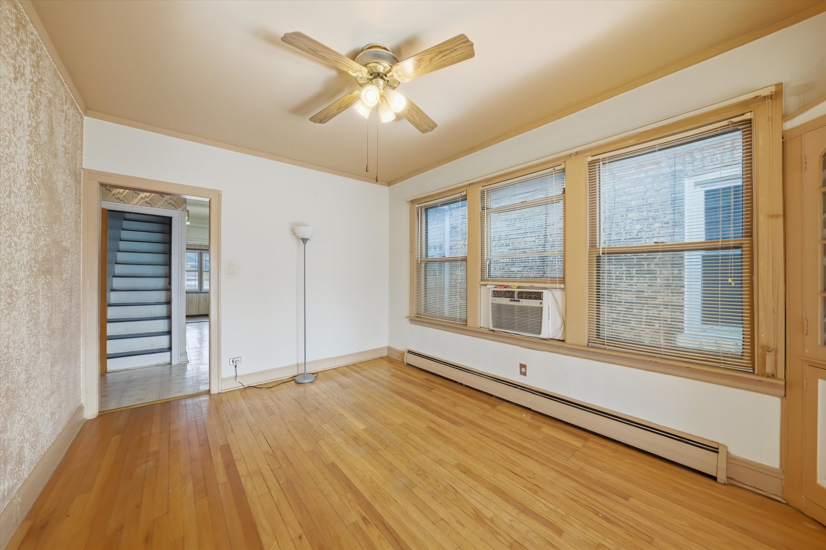 3822 West 64th Street Chicago, IL 60629 - Photo 4 of 33 a view of an empty room with a window and wooden floor