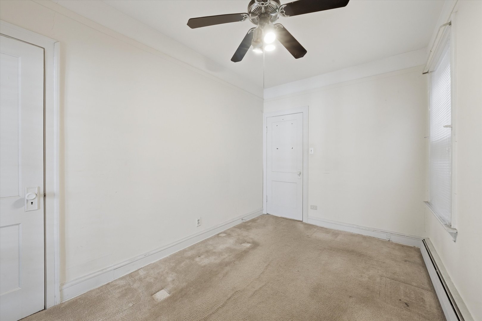3822 West 64th Street Chicago, IL 60629 - Photo 6 of 33 an empty room with a chandelier fan