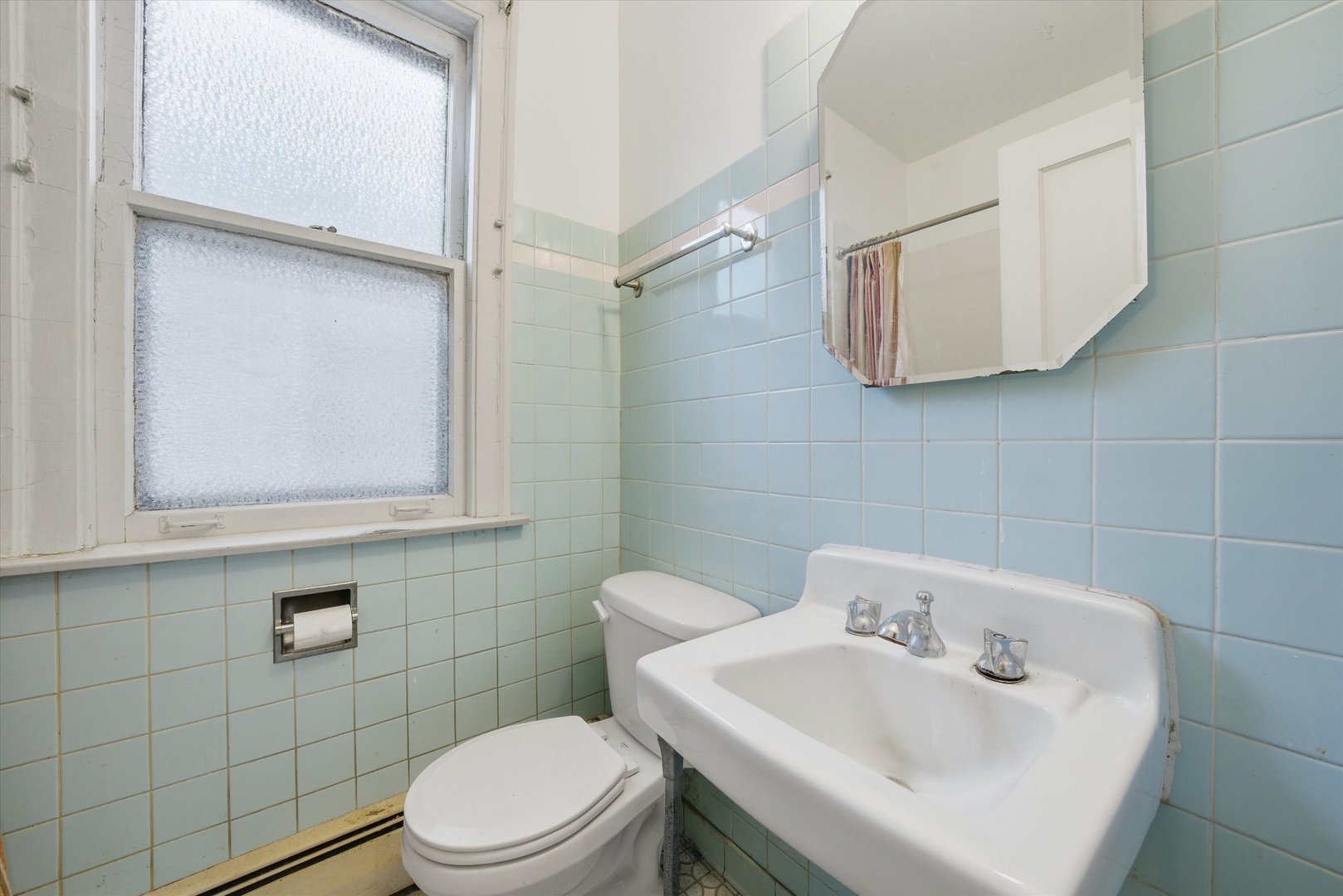 3822 West 64th Street Chicago, IL 60629 - Photo 7 of 33 a bathroom with a sink a toilet and mirror