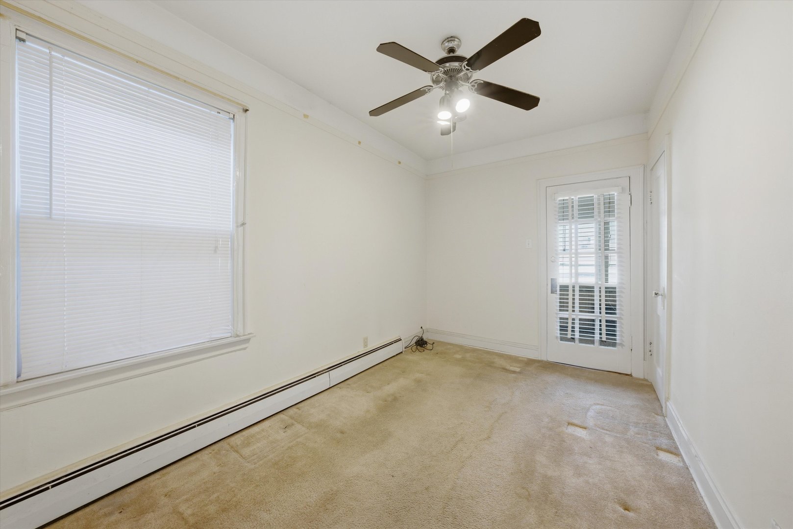 3822 West 64th Street Chicago, IL 60629 - Photo 8 of 33 an empty room with chandelier fan and windows